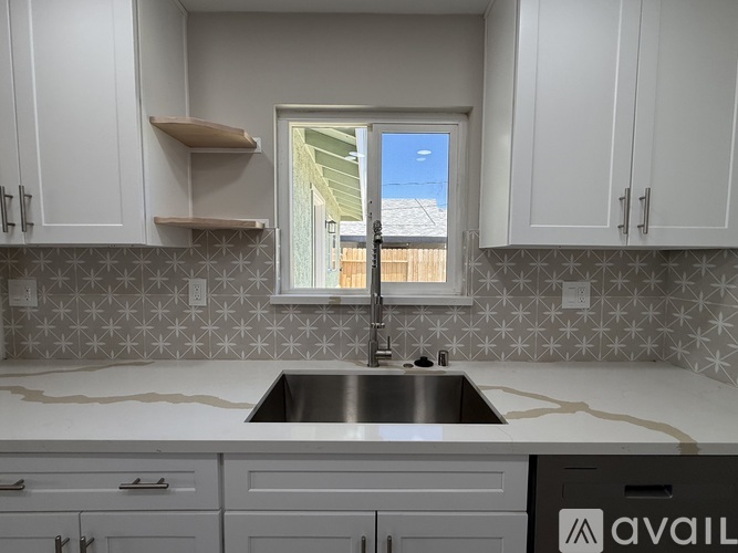 A kitchen with a window and a sink.