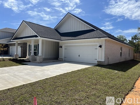 A two-story house with a garage on the side.