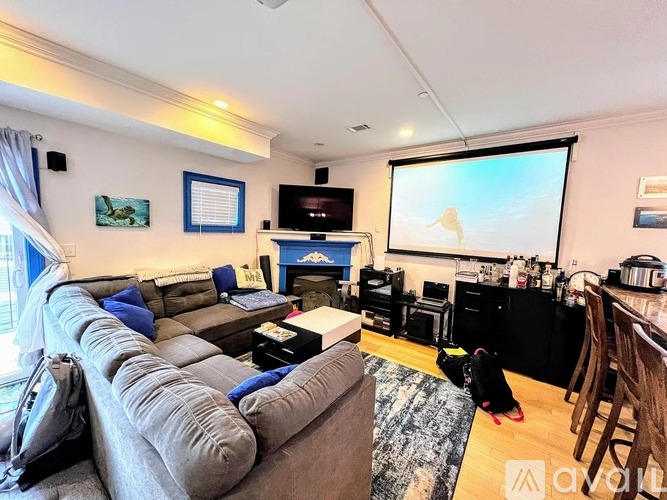A living room with a grey couch and a television.