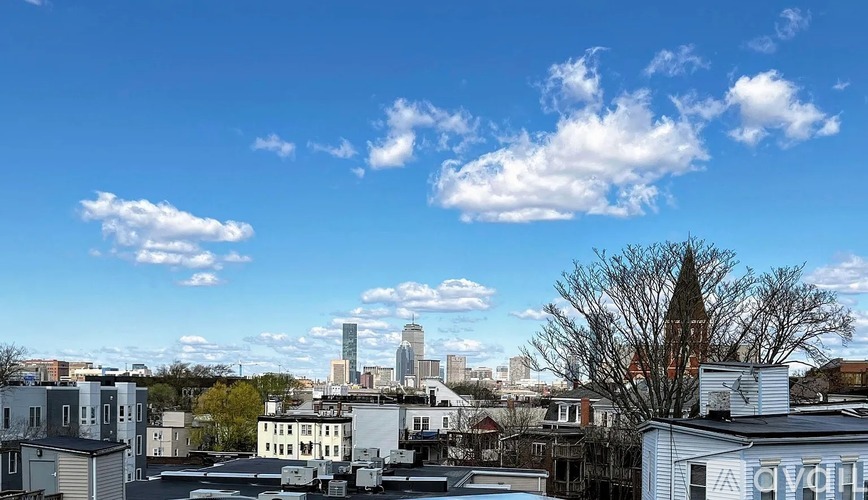 A cityscape with buildings and a clear sky.