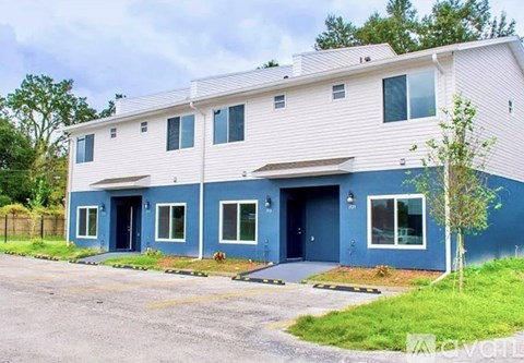 A two story building with blue and white siding.