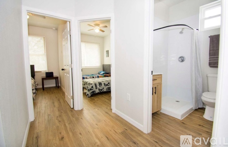 A small bedroom with a bed and a toilet.