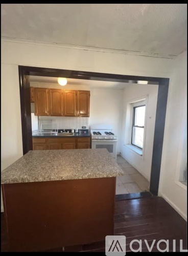 A kitchen with wooden cabinets and a granite countertop.