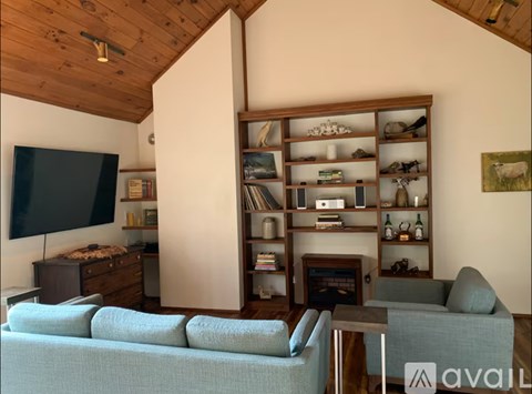 A living room with a grey couch and a television.