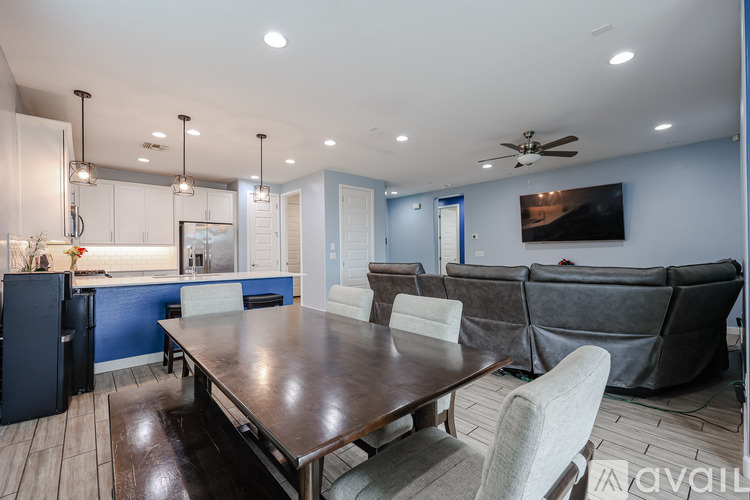 A modern dining room with a wooden table and chairs.