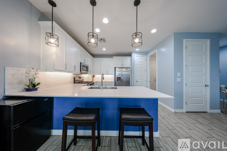 A kitchen with a bar stool and a counter.