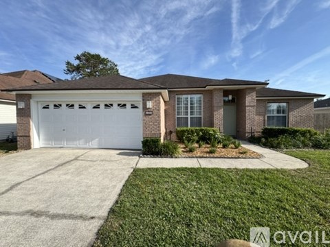 A house with a white garage door is for sale.