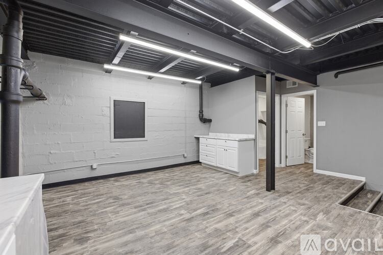A spacious room with a white desk and a white cabinet.