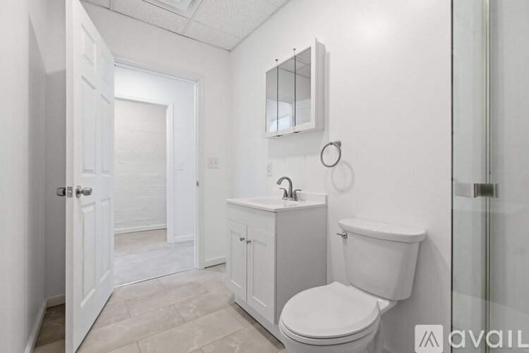 A white brick wall with a glass shelf and a door.