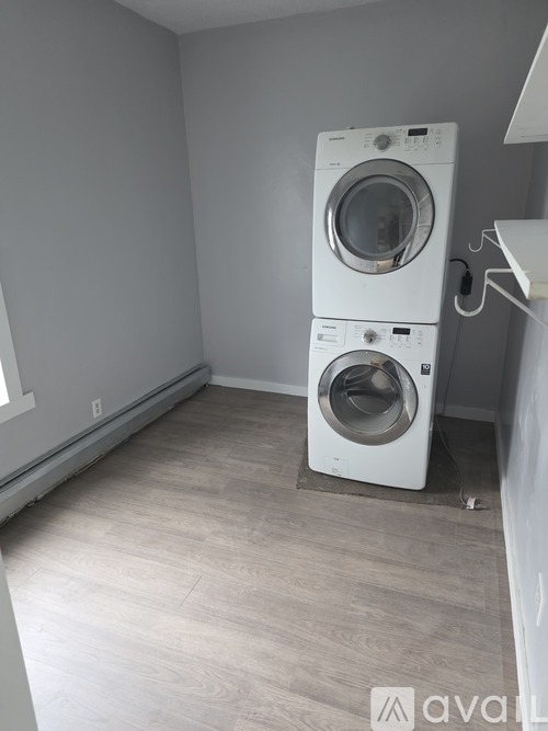 A laundry room with a washer and dryer stacked on top of each other.