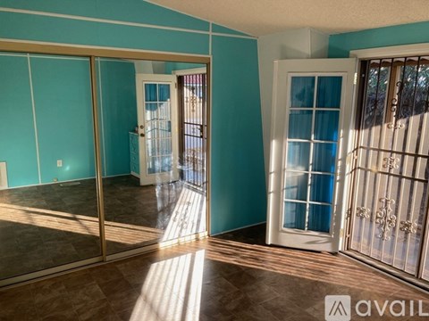 A room with a sliding glass door leading to a balcony.