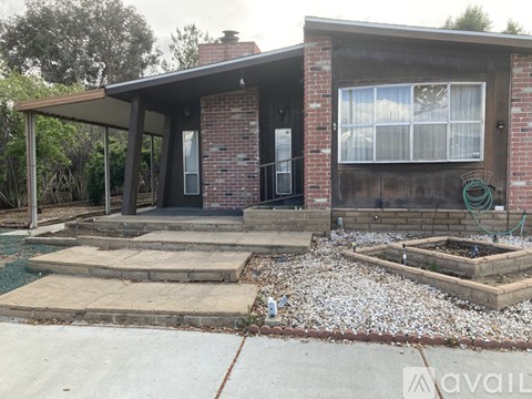 A house with a front porch and a small garden.