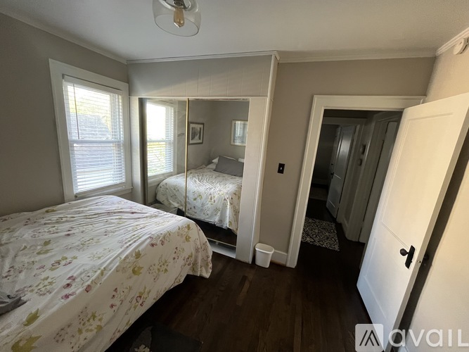 A bedroom with two beds and a dresser.