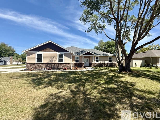 A house with a tree in front of it.