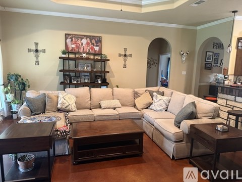 A living room with a large sectional sofa and a coffee table.