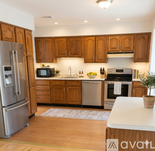 A kitchen with wooden cabinets and a refrigerator on the left.