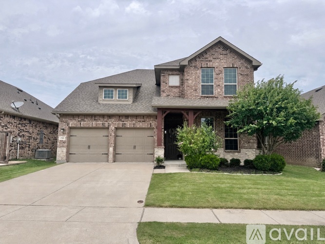 A house with a garage and a driveway in front.