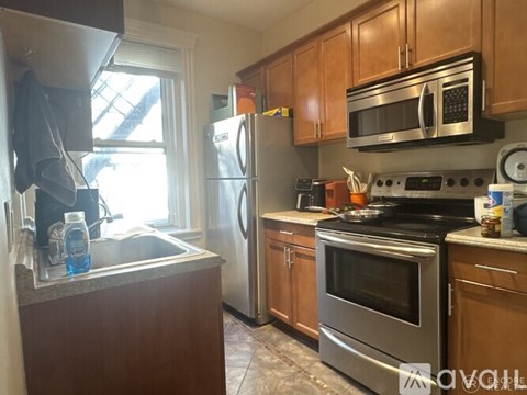 A kitchen with wooden cabinets and stainless steel appliances.