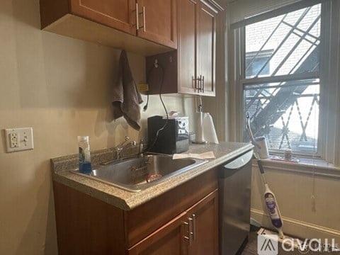 A kitchen with a sink and a window.