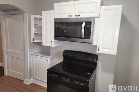 A kitchen with a black oven and microwave.