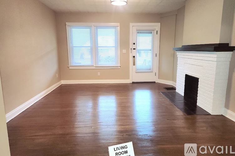A living room with a fireplace and a sign that says "Living Room".