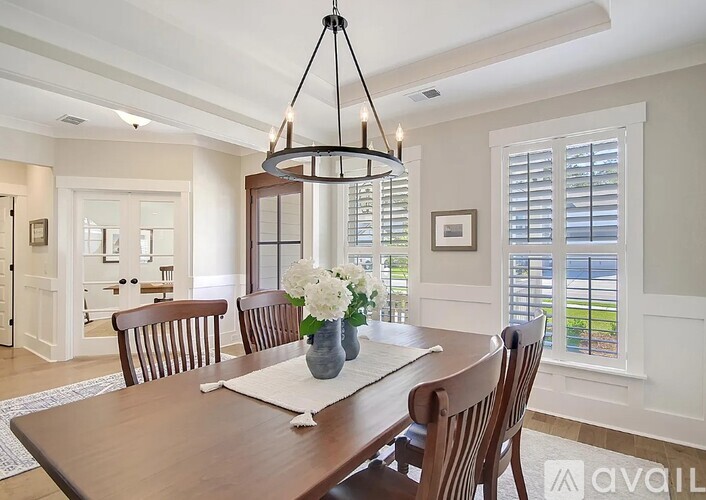 A dining room with a wooden table and chairs.