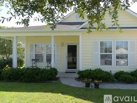 A house with a front porch and white columns.