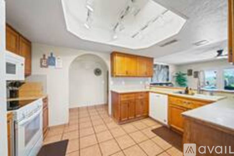 A kitchen with wooden cabinets and a white countertop.