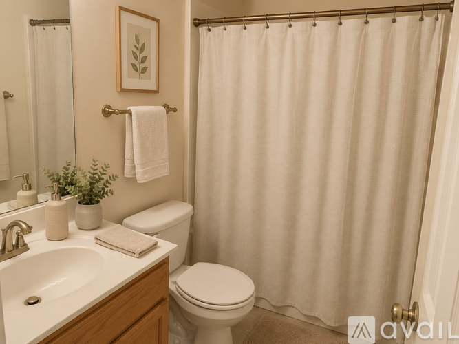 A bathroom with a red rug and a shower curtain with a red and white pattern.