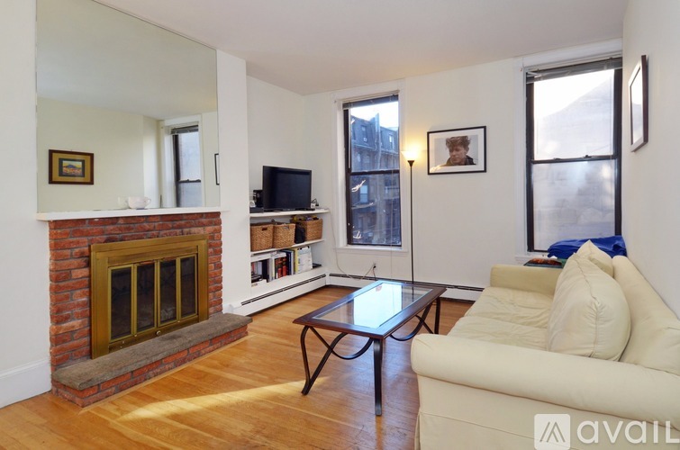 A living room with a fireplace and a couch.