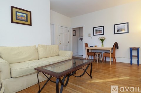 A living room with a white couch and a coffee table.