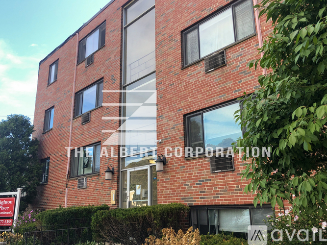 A red brick building with the name "Albert Corporation" on the front.