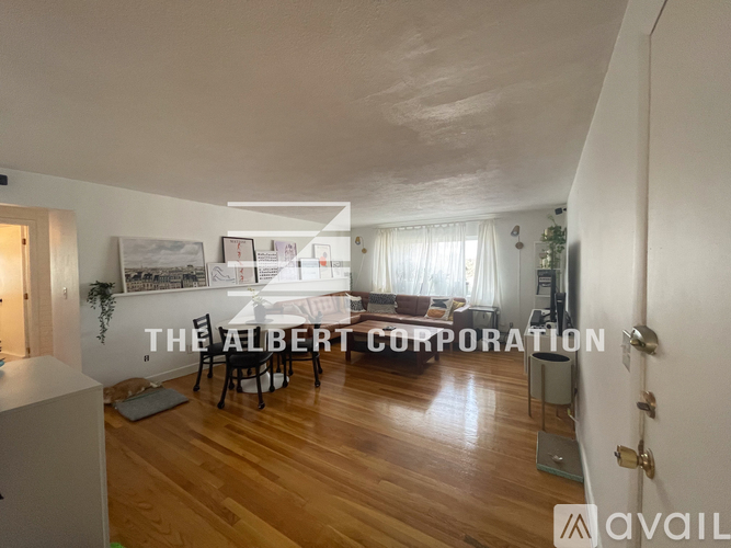 A living room with a dining table and chairs in the middle of the room.