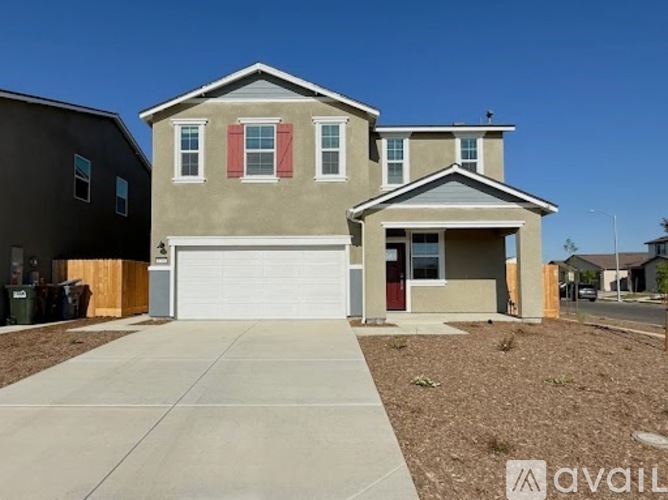 A two-story house with a garage is for sale.