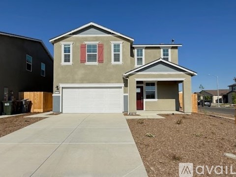 A two-story house with a garage is for sale.