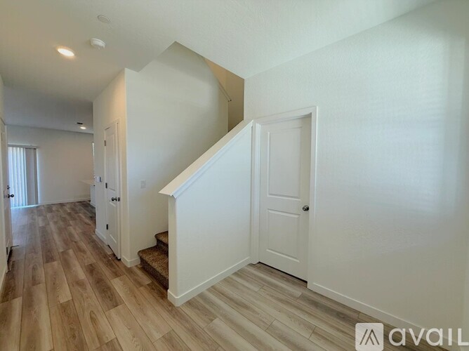 A hallway with a staircase leading to the second floor.