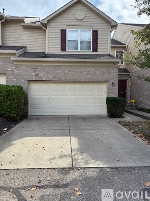 A house with a garage door and a driveway.