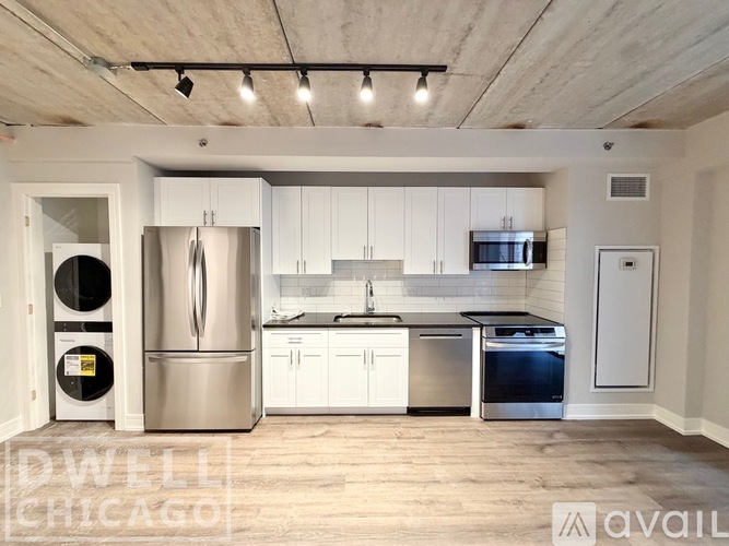 A modern kitchen with stainless steel appliances and white cabinets.