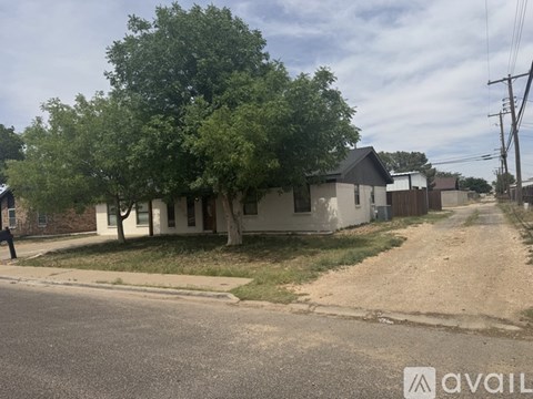 A house with a tree in front of it.