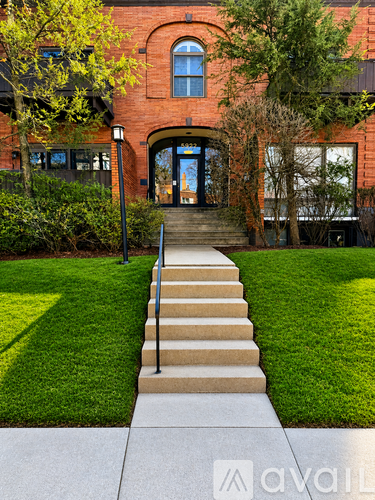 A red brick building with a set of stairs leading to the entrance.