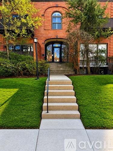 A red brick building with a set of stairs leading to the entrance.