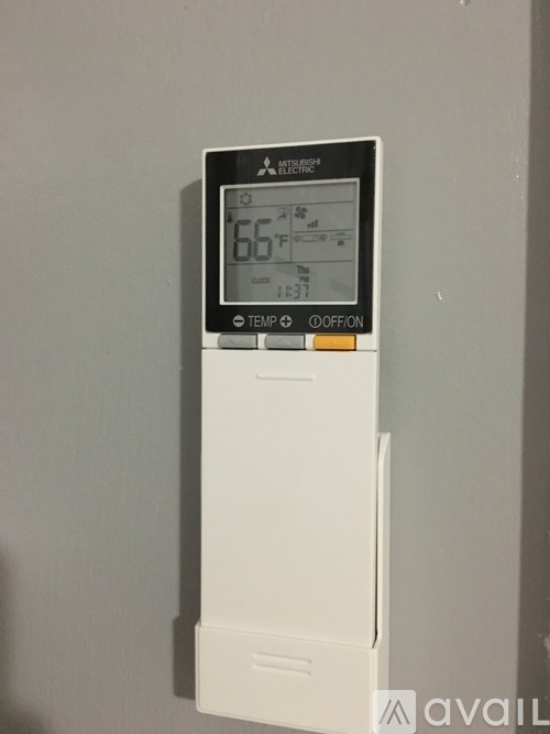 A Mitsubishi electric thermostat is set to 66 degrees.