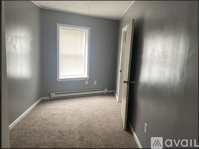 A room with grey walls and a window.