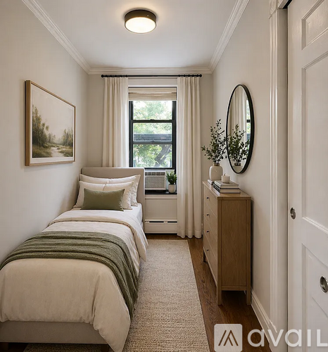 A bedroom with a bed, a dresser, and a mirror.