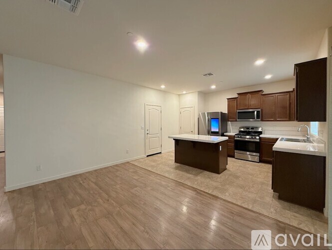 A kitchen with a countertop, microwave, oven, and sink is available for rent.