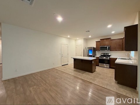 A kitchen with a countertop, microwave, oven, and sink is available for rent.