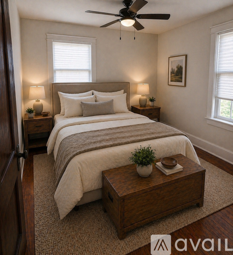 A bedroom with a large bed and a ceiling fan.