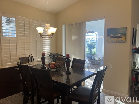 A dining room with a table set for six.