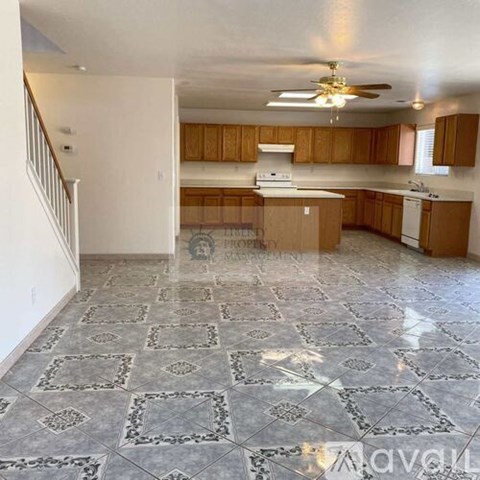A kitchen with wooden cabinets and a tile floor.