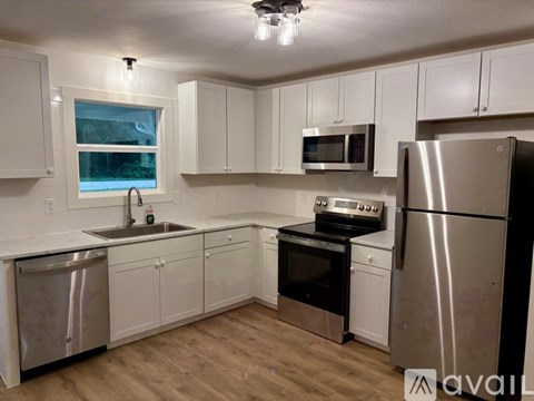 A kitchen with white cabinets and stainless steel appliances.